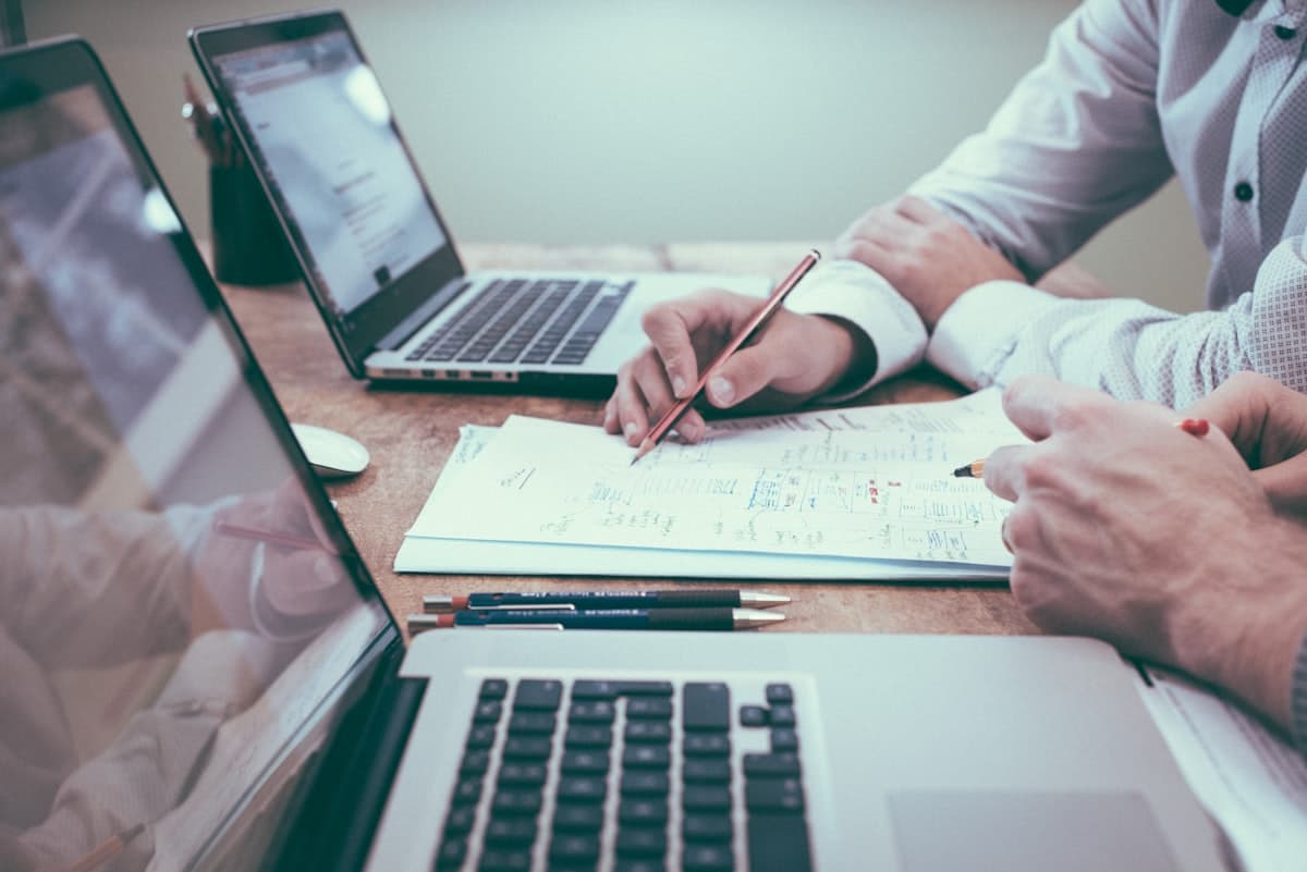 Business owner reviewing loan documents and financials at a desk
