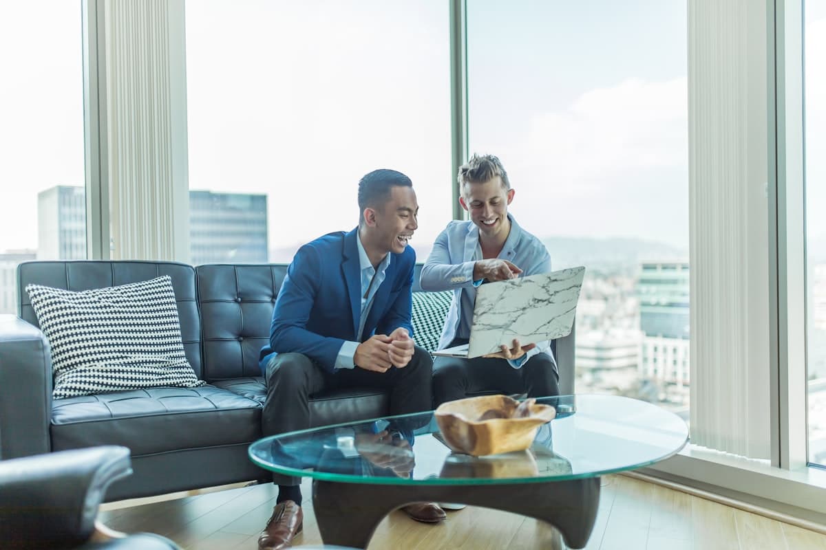 Two entrepreneurs reviewing a business plan on a laptop in a modern office